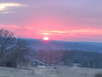 Scenic view of field against sky during sunset