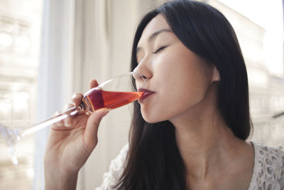 Woman drinks a glass of wine