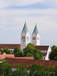 View of trees and buildings against sky