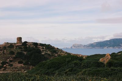 Scenic view of sea and mountains against sky