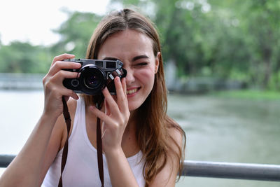 Portrait of woman photographing