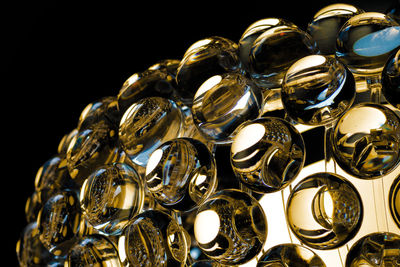 Close-up of gold colored light painting against black background