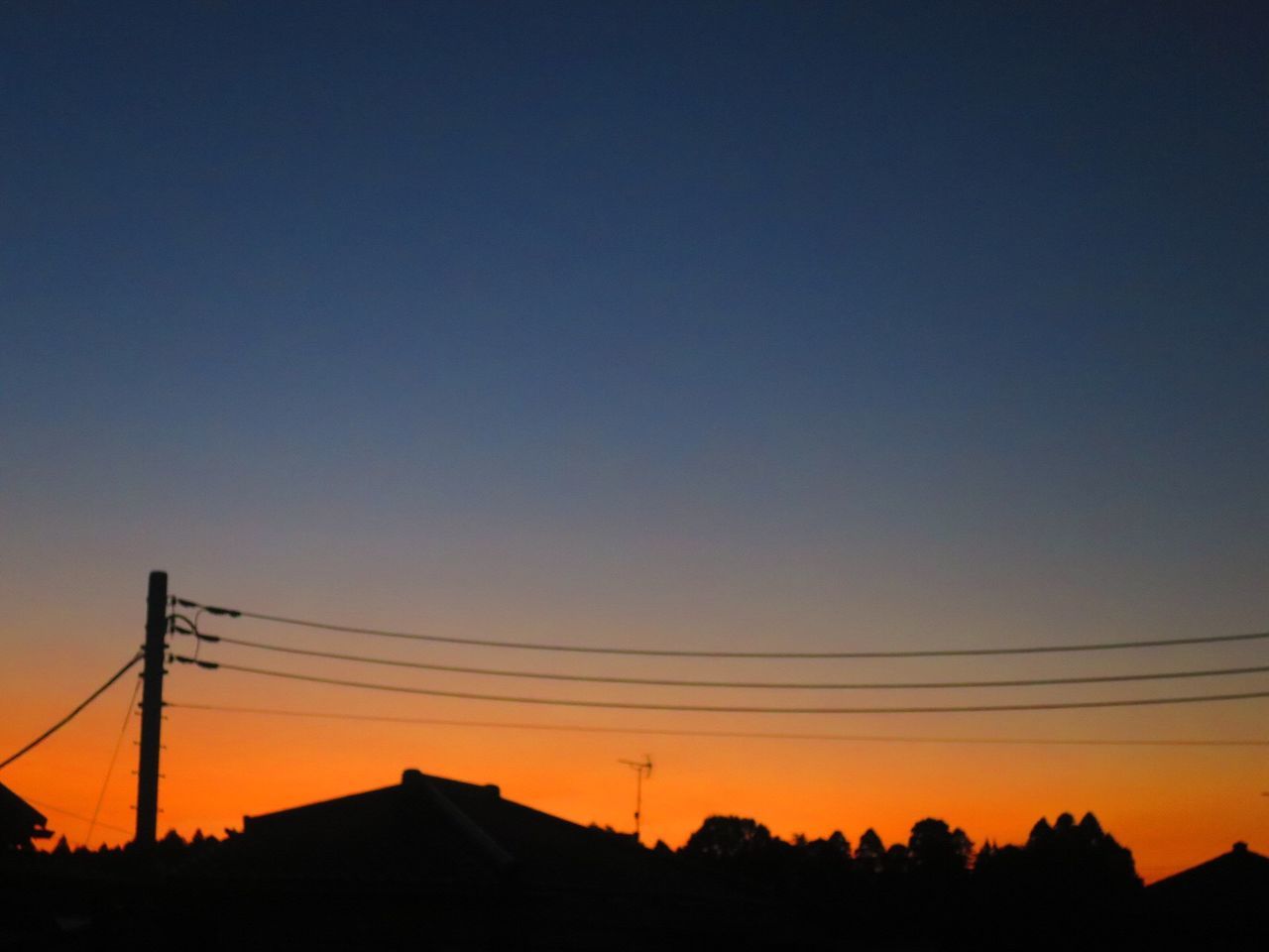 SILHOUETTE ELECTRICITY PYLONS AGAINST ROMANTIC SKY AT SUNSET