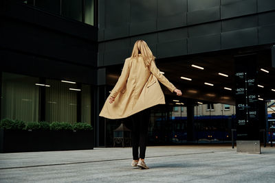 Rear view of woman walking in building