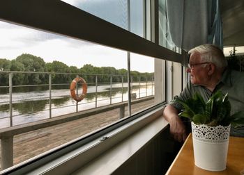 Man looking through window