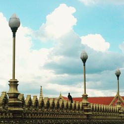 Low angle view of building against cloudy sky