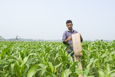 Young man standing in field