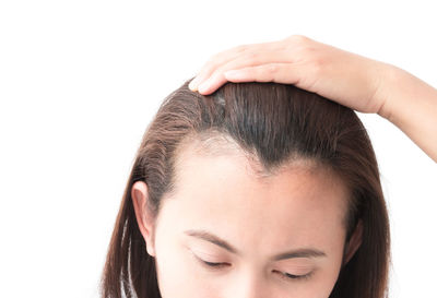 Close-up of young woman over white background