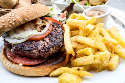 Close-up of burger with french fries and dip