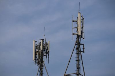 Low angle view of communications tower against sky