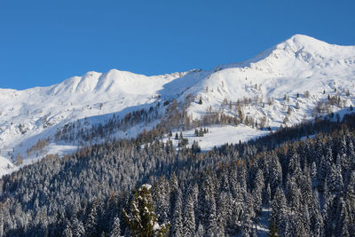 Scenic view of snowcapped mountains against clear sky