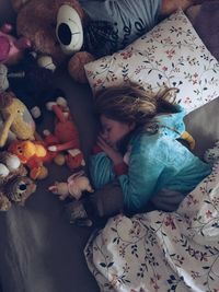 High angle view of girl sleeping on bed at home