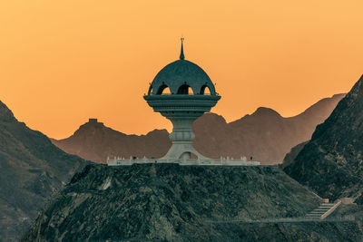 Traditional building against sky during sunset