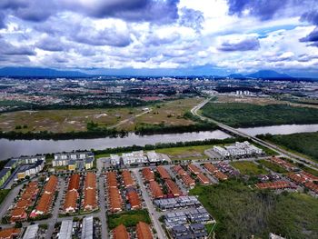 High angle view of houses in town against sky