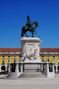 Low angle view of statue against clear blue sky