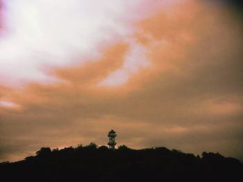 Low angle view of silhouette trees against sky at sunset