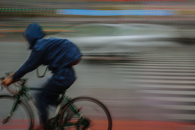 Man riding bicycle on street