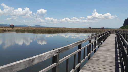 Pier over lake against sky