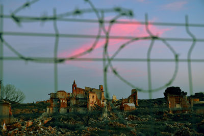 Old ruins at belchite against sky during sunset