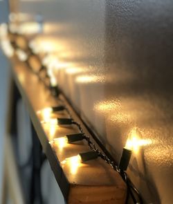 Close-up of illuminated lighting equipment on metal