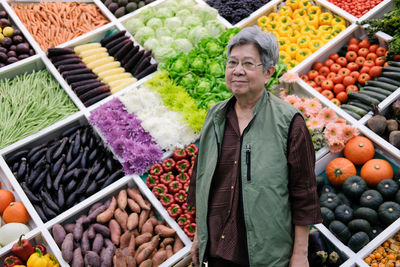 Portrait of senior woman standing at market stall