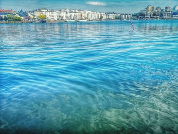 Scenic view of swimming pool by buildings in city