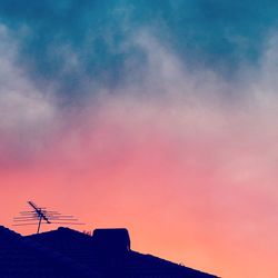 Silhouette of building against sky during sunset