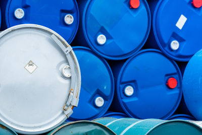 Old chemical barrels. blue and green oil drum. steel and plastic oil tank. toxic waste warehouse. 