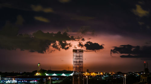 Illuminated buildings against sky at night