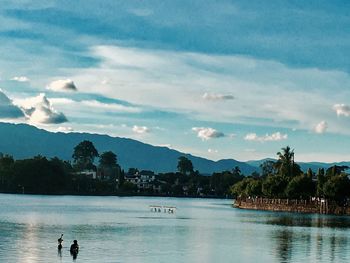 Scenic view of swimming pool by lake against sky