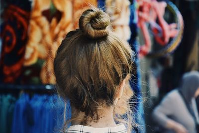 Rear view of young woman standing at market