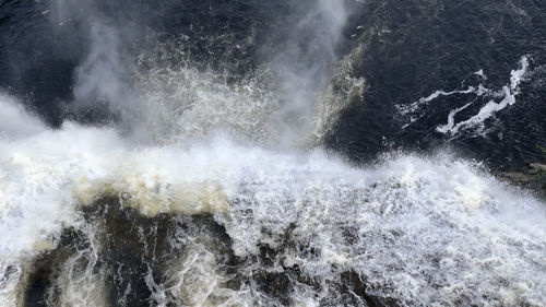 View of waves breaking on rocks