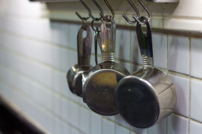 Close-up of utensils hanging in kitchen