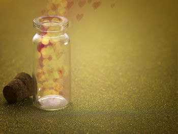 Close-up of glass bottle on glitter