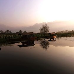 Scenic view of lake against sky at sunset