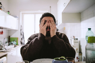 Portrait of man sitting at home