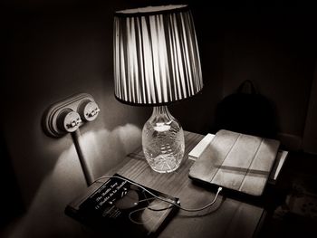 Close-up of electric lamp on table at home
