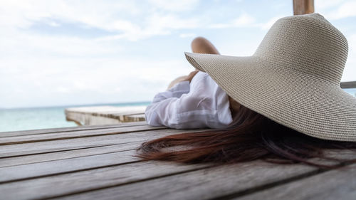 Rear view of woman wearing hat on beach