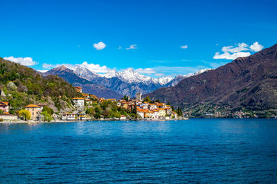 The village of santa maria rezzonico, on lake como, on a spring day, with its tower and the alps.