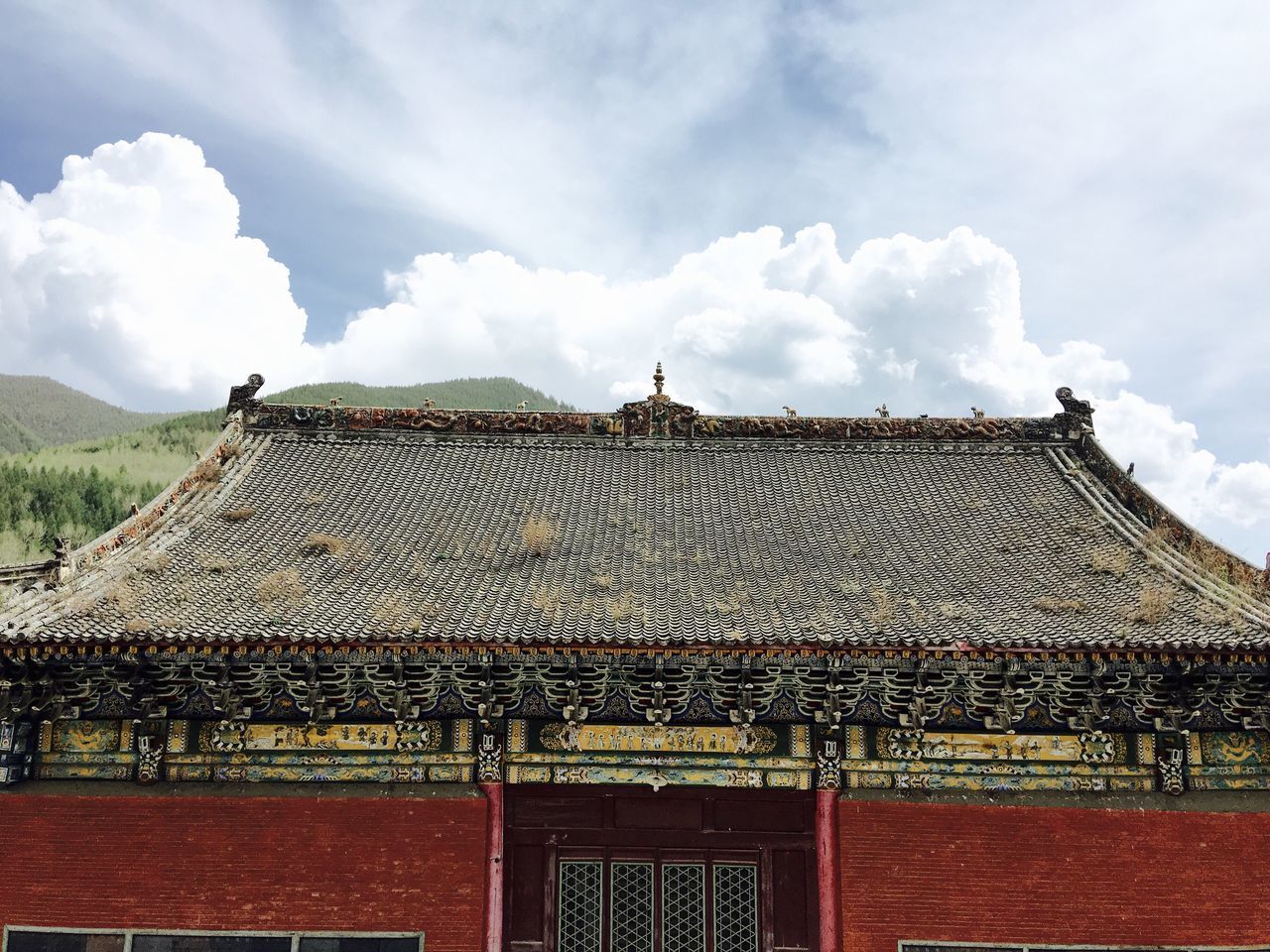 sky, architecture, built structure, building exterior, cloud - sky, low angle view, roof, cloud, cloudy, place of worship, religion, spirituality, day, history, outdoors, temple - building, roof tile, house, cultures