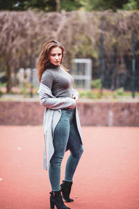 Portrait of smiling young woman standing outdoors