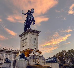 Low angle view of statue against cloudy sky