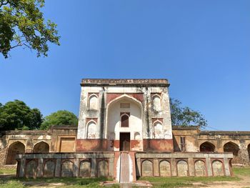 Low angle view of historic building against clear blue sky