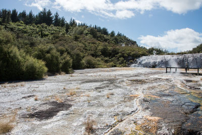 Scenic view of waterfall against sky