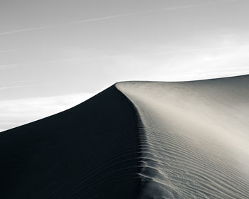 Sand dunes against sky