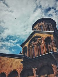 Low angle view of building against cloudy sky