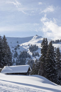 Scenic view of snow covered mountains against sky