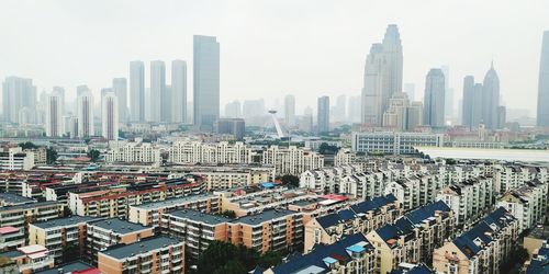 Aerial view of modern buildings in city against sky