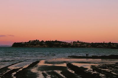 Scenic view of sea against clear sky during sunset