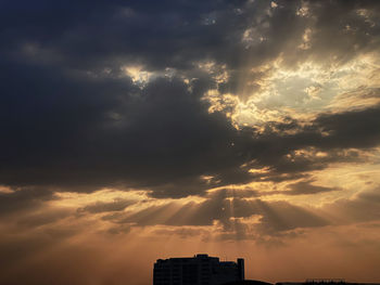 Low angle view of silhouette buildings against sky during sunset